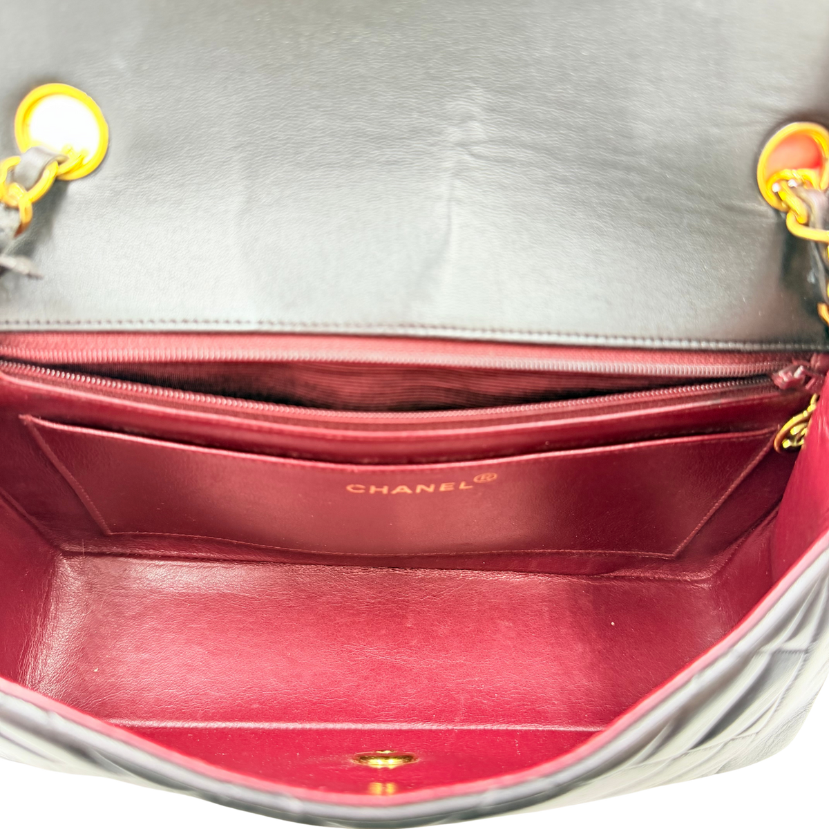 Chanel Diana Medium flap bag, burgundy interior showing Chanel logo, slip pocket and zip pocket
