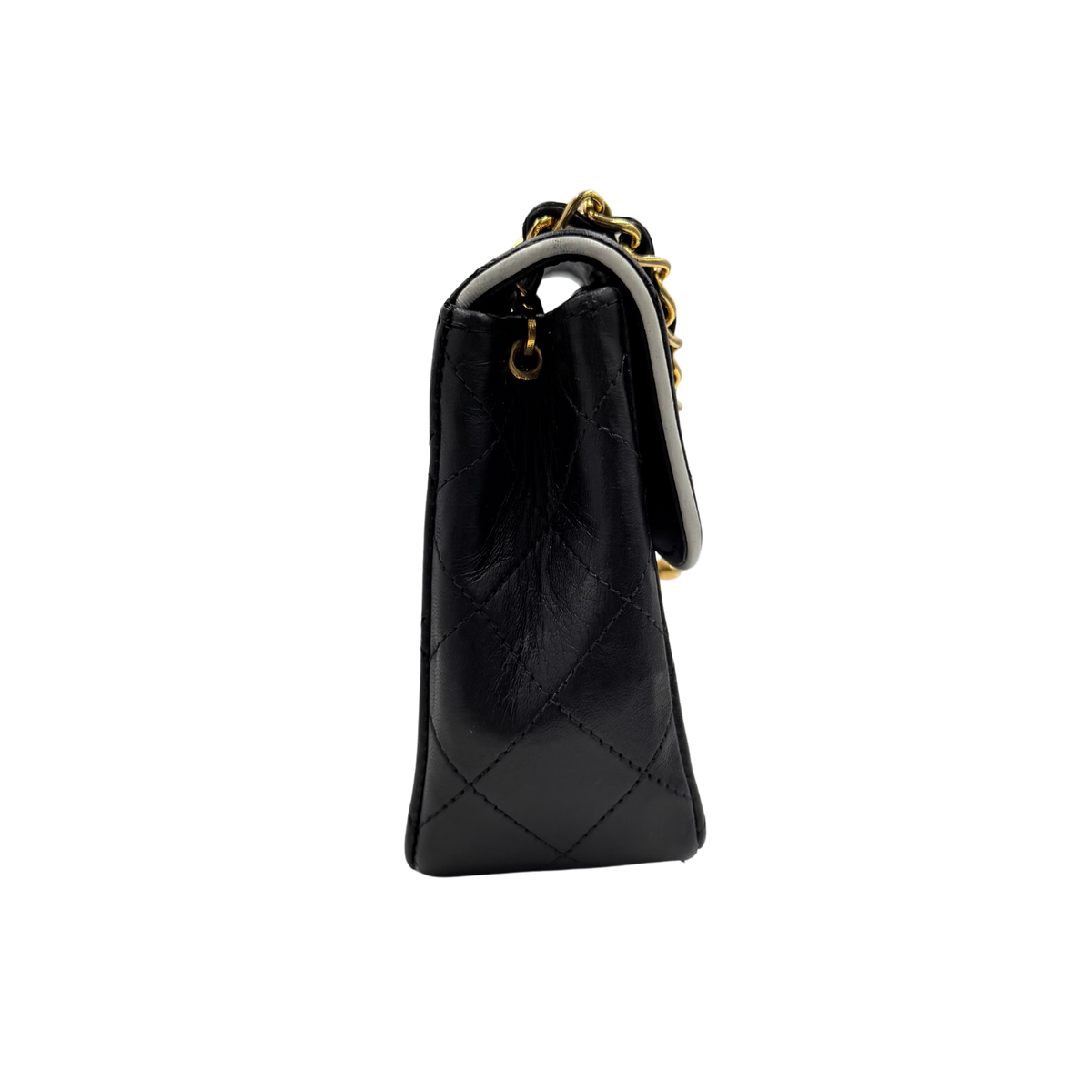 Chanel black quilted lambskin mini flap, side profile with leather-interwoven chain strap