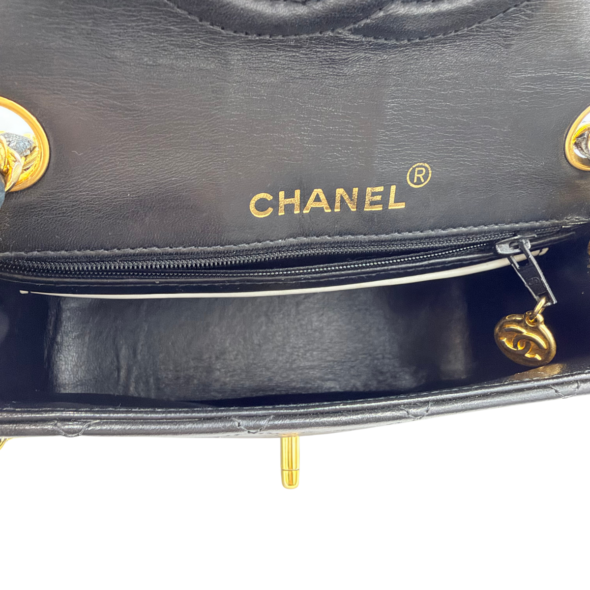 Chanel mini flap black interior with Chanel stamp, zip pocket and CC zipper pull